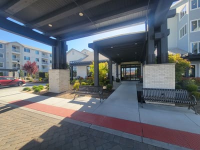 Entrance area of an assisted living facility with benches and landscaping