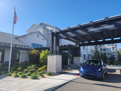 Front entrance of a nursing home facility with outdoor landscaping