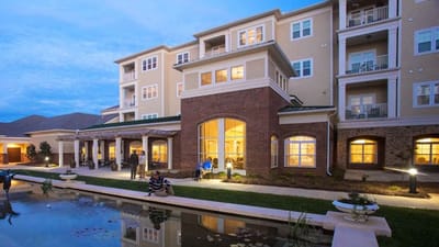 Exterior view of a senior living facility at dusk