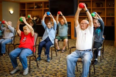 Residents participating in an exercise class indoors