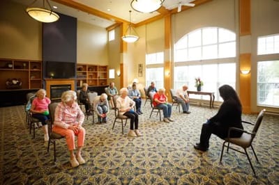 Residents participating in a seated group activity in a common area