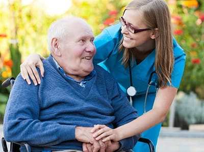 Caregiver interacting with a resident in a garden