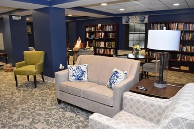 Cozy common area with seating and shelves of books