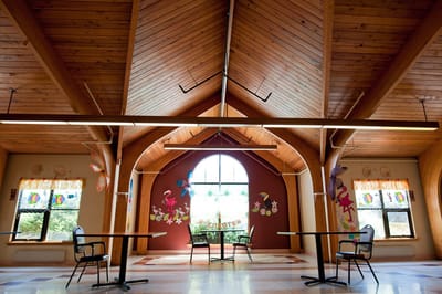 Interior view of a bright community room with wooden ceiling