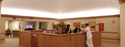 Reception area with staff assisting residents
