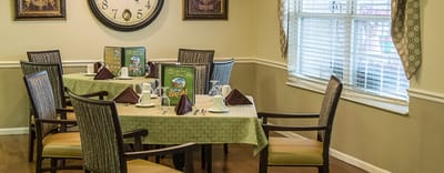 Dining area setup with tables and decorations