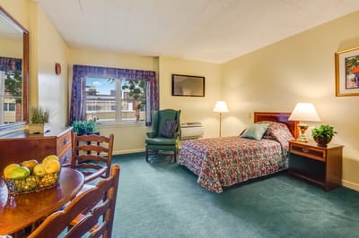 Cozy resident room with bed and seating area