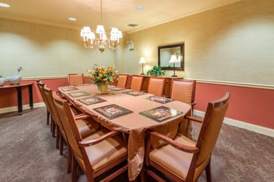 Dining room with a large table and floral centerpiece