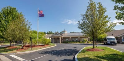 Building exterior with landscaped area and flagpole