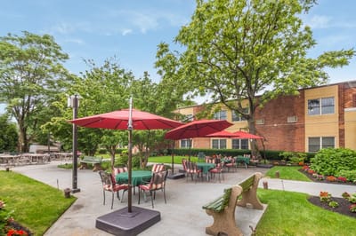 Outdoor dining area with red umbrellas and seating