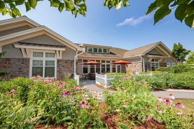 View of the facility's exterior with flowers and patio