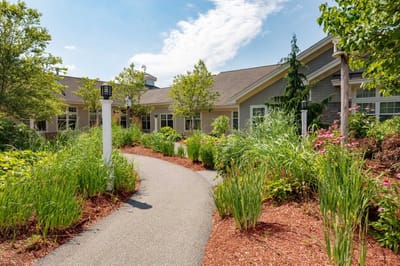 Pathway leading to a senior living facility with gardens