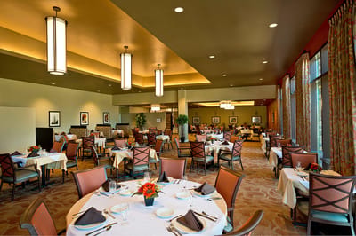 Elegant dining room with tables set for a meal