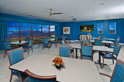 Bright and inviting common area with dining tables