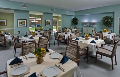 Bright dining room with tables set for meals