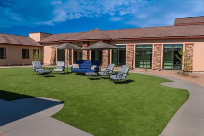 Patio lounge area with seating in sunny outdoor space