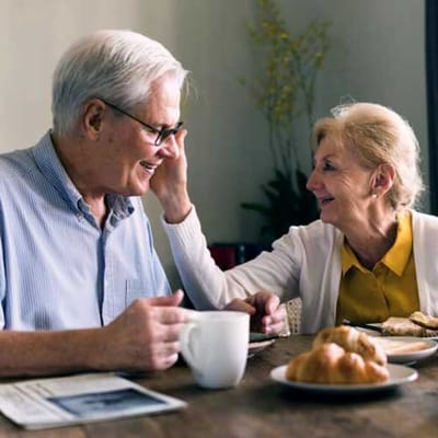 Joyful elderly couple sharing a meal together