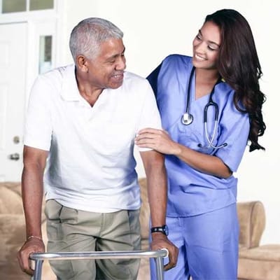 Staff assisting a resident in a cozy interior