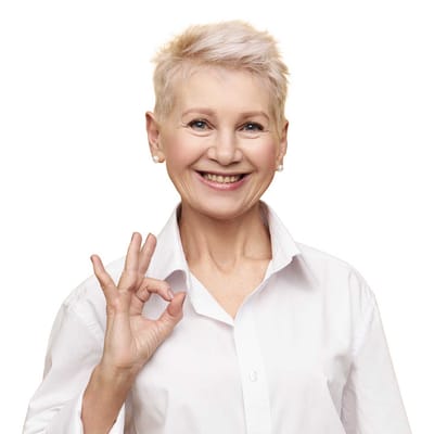 Cheerful elderly woman giving an 'okay' gesture