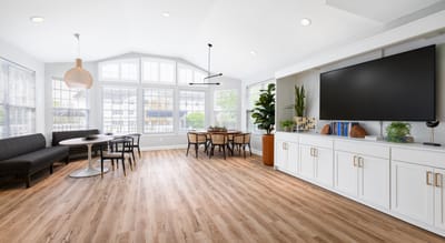 Bright common area with seating and dining table