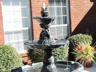 A decorative fountain in an outdoor garden area