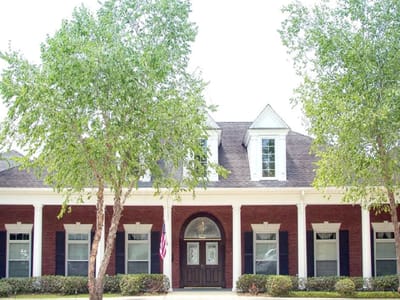 Exterior view of a senior living facility with trees