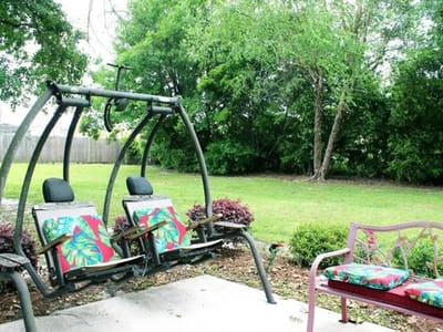 Outdoor seating area with swings and benches