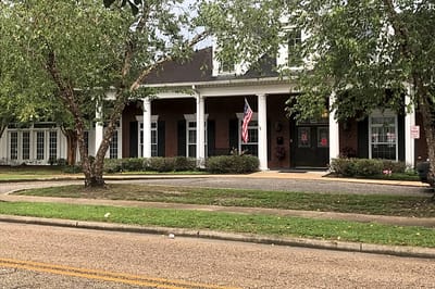 Exterior view of Dauphin Way Senior Living with gardens