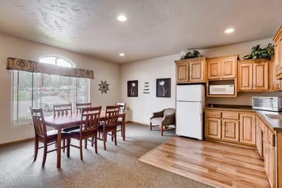 Bright common area with dining table and kitchen