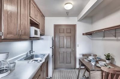 Cozy kitchenette with dining area in a resident room