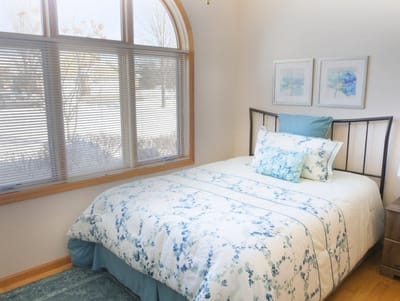 Cozy resident bedroom with floral bedding and natural light
