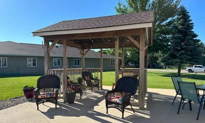 Covered seating area in a landscaped outdoor space