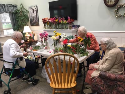 Residents engaged in a flower arranging activity