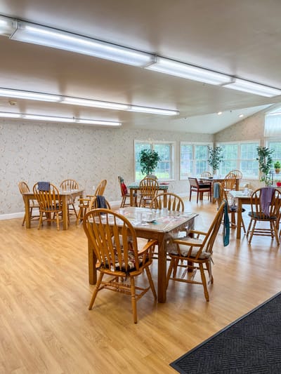 Bright dining area with wooden tables and chairs