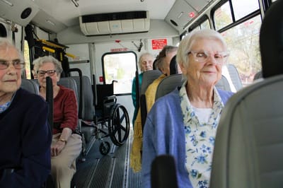 Residents enjoying a ride in a facility shuttle bus