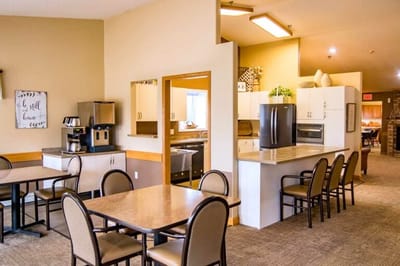 Bright dining area with tables and kitchen space