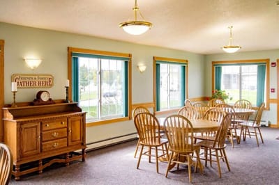 Bright dining area with wooden tables and chairs
