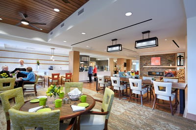 Residents enjoying a meal in a vibrant dining area