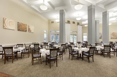 Dining area with neatly set tables and chairs
