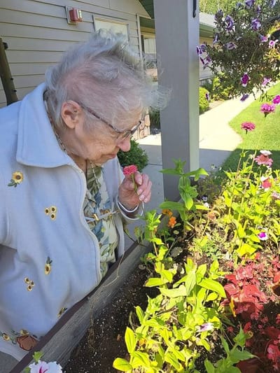 Elderly woman enjoying gardening outdoors