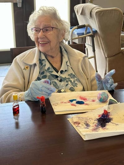 Elderly resident engaged in painting activity