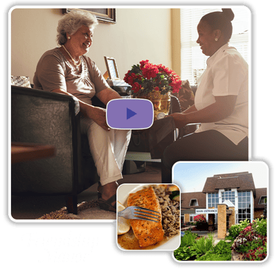 A resident and staff member engaged in conversation with a meal visible