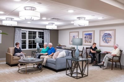 Residents relaxing in a common area with modern decor