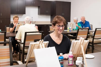Residents enjoying a painting activity in a common area
