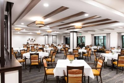 Bright dining room with tables set for meals