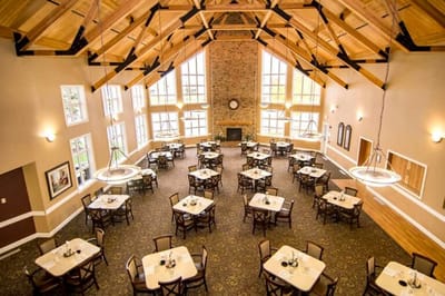 Dining area in a senior living facility with large windows
