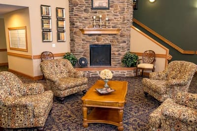 Cozy common area with seating and stone fireplace