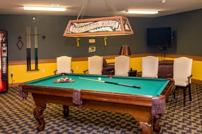 Interior game room with a pool table and seating