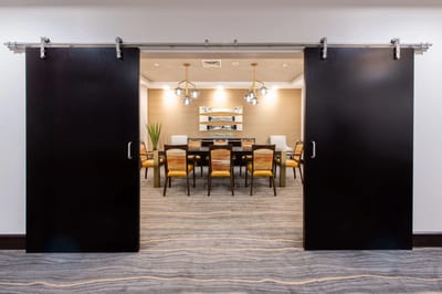 Interior view through sliding doors into a dining area