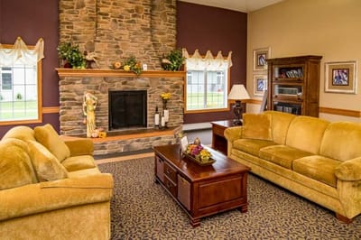 Cozy common area with sofas and a fireplace